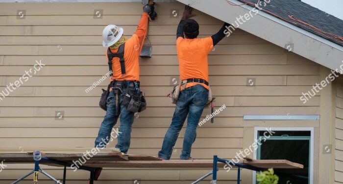 Construction Workers Installing Vinyl Siding Facade Stock Photo ...